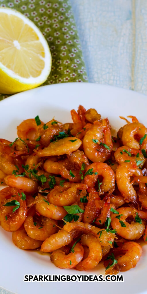 Grilled honey garlic shrimp at plate on wooden table