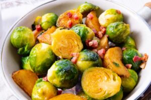 oven honey roasted Brussels sprouts with bacon and potatoes can be served as a Thanksgiving side dish or Christmas main dish