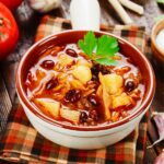 A steaming bowl of Red Beans and Cabbage Soup, a nutritious and low-calorie dish, perfect for weight watchers and family meals.
