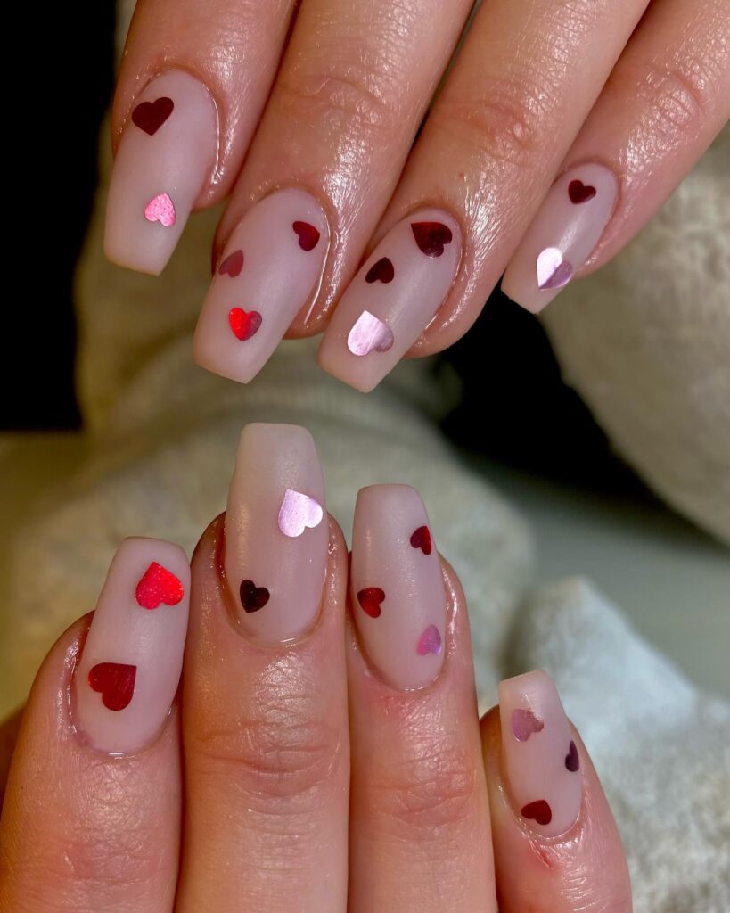 Pink and red Valentine's Day nails with heart designs