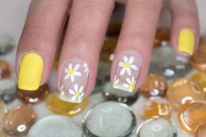 Vibrant spring nail art featuring 3D floral designs, pastel gradients, and playful abstract patterns, perfect for a fresh and stylish spring look.