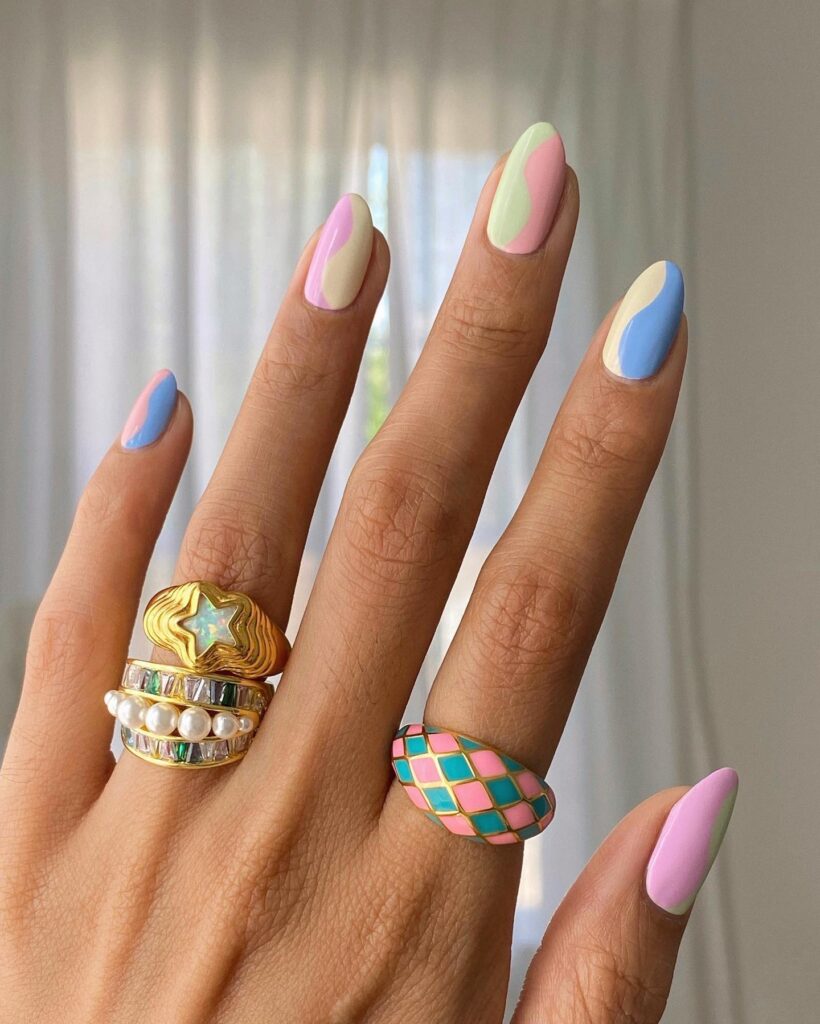 Vibrant spring nail art featuring 3D floral designs, pastel gradients, and playful abstract patterns, perfect for a fresh and stylish spring look