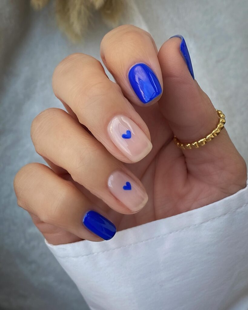 Assorted blue nails designs featuring light blue nails, royal blue acrylic nails, and blue french tip nails on various hand poses.