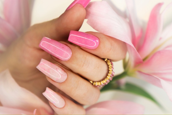 Bright spring acrylic nails with pastel colors and floral designs perfect for spring break.