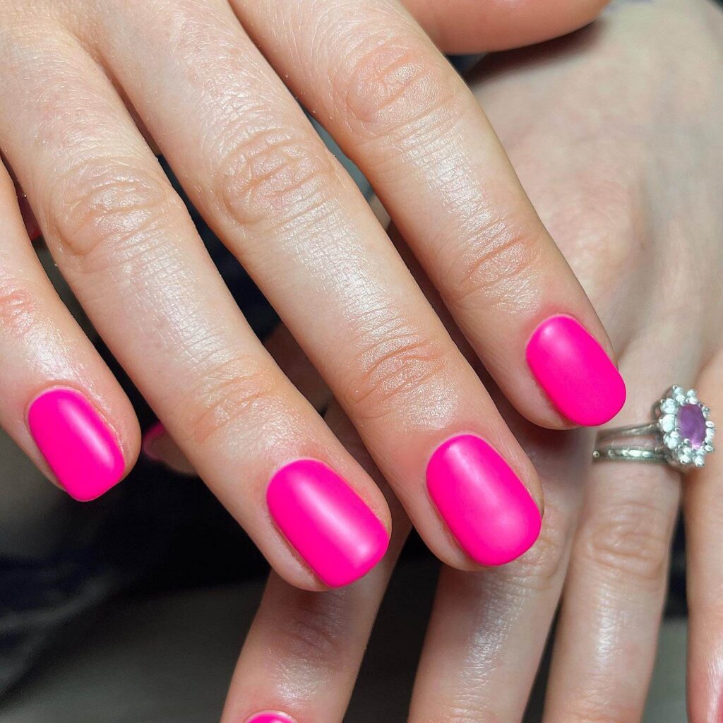 Variety of summer pink nail polishes and designs, including hot pink, neon, and light pink shades, perfect for trendy summer manicures.