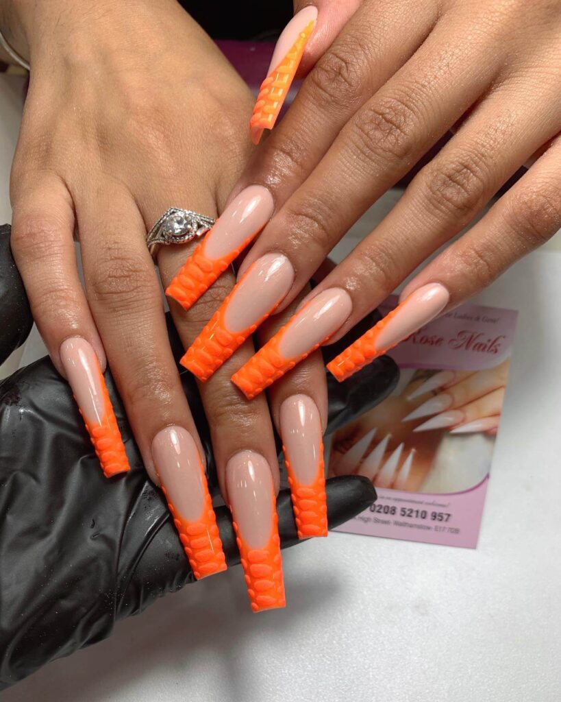 trendy summer nails with a range of orange shades including neon, burnt, and glitter finishes, ideal for seasonal flair.