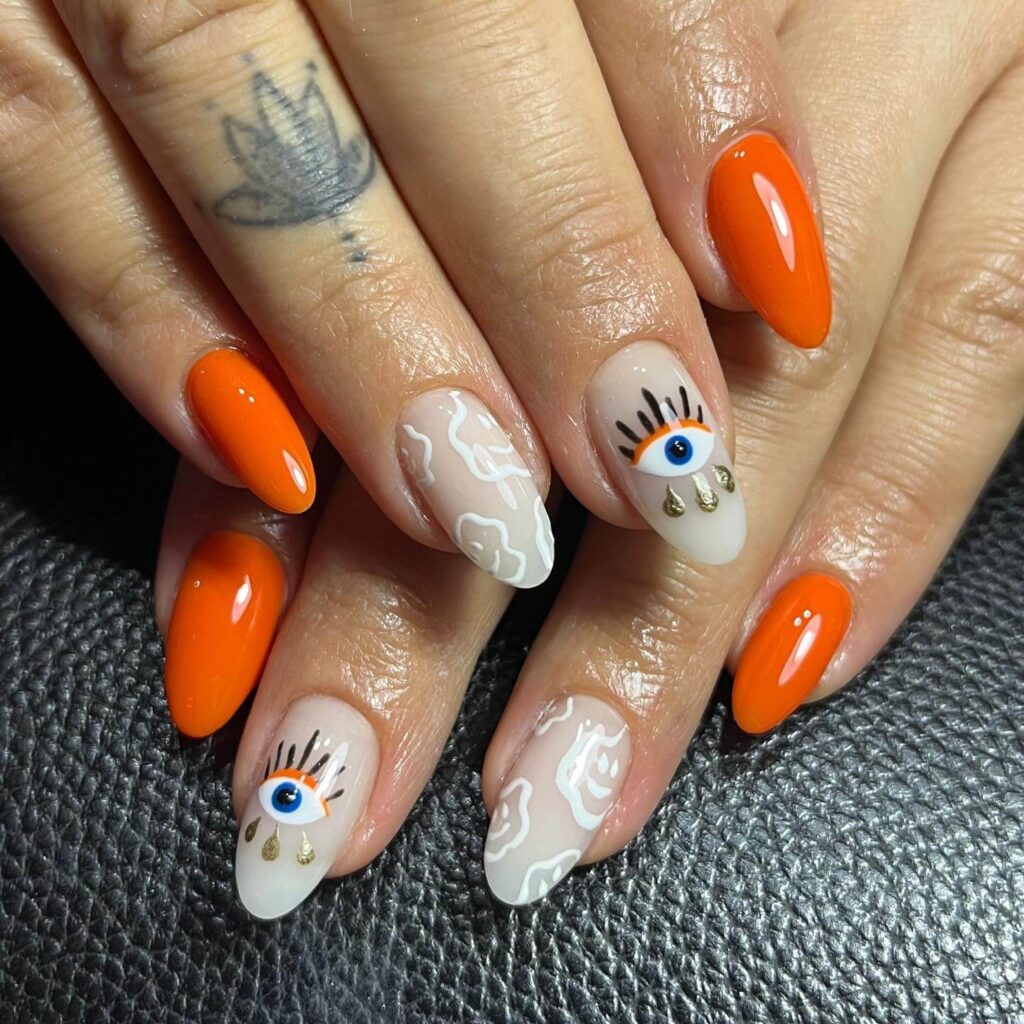 trendy summer nails with a range of orange shades including neon, burnt, and glitter finishes, ideal for seasonal flair.