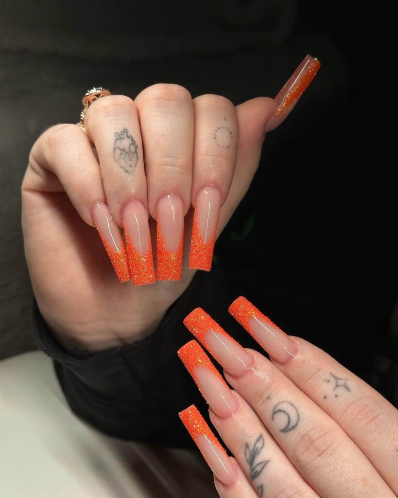 trendy summer nails with a range of orange shades including neon, burnt, and glitter finishes, ideal for seasonal flair.