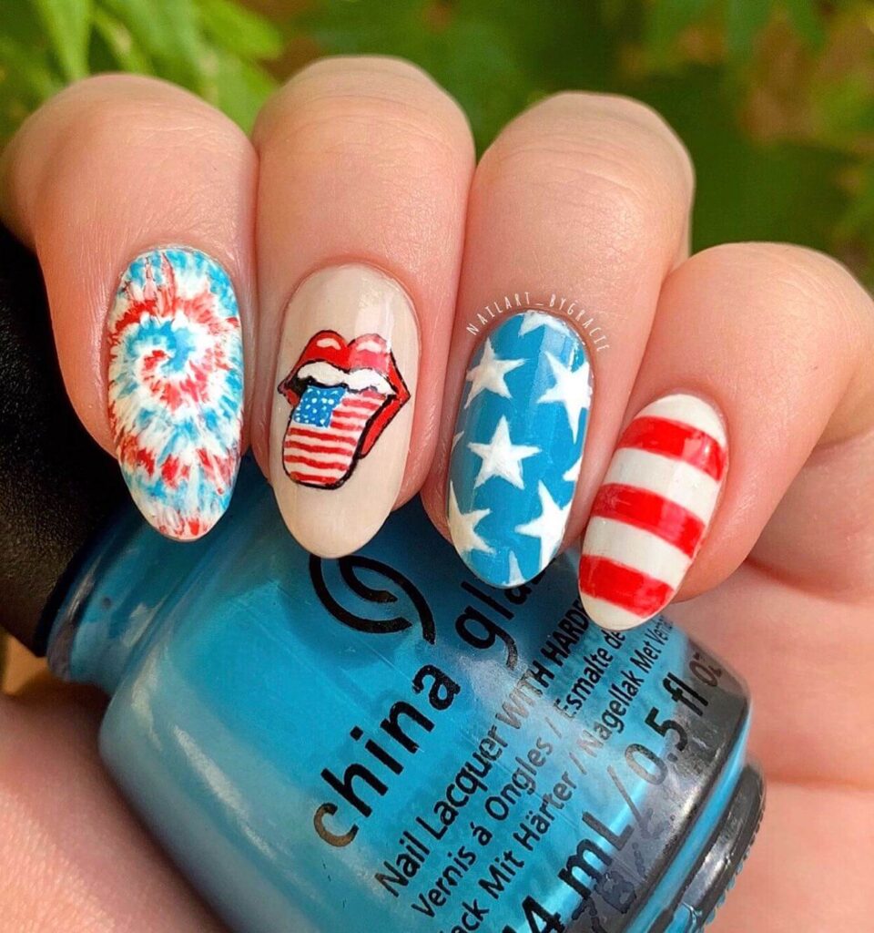 Colorful 4th of July nails featuring stars, stripes, and glitter in red, white, and blue.