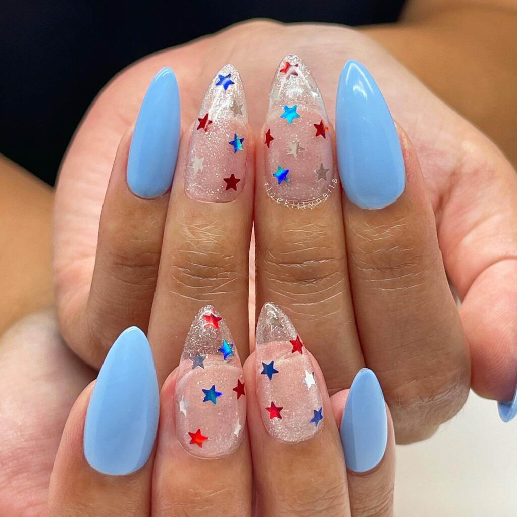 Colorful 4th of July nails featuring stars, stripes, and glitter in red, white, and blue.