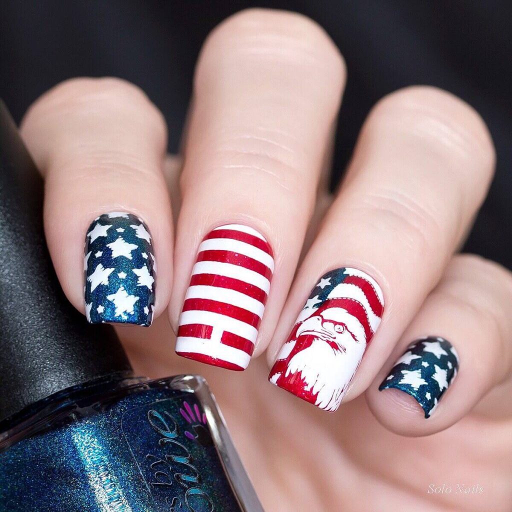 Colorful 4th of July nails featuring stars, stripes, and glitter in red, white, and blue.