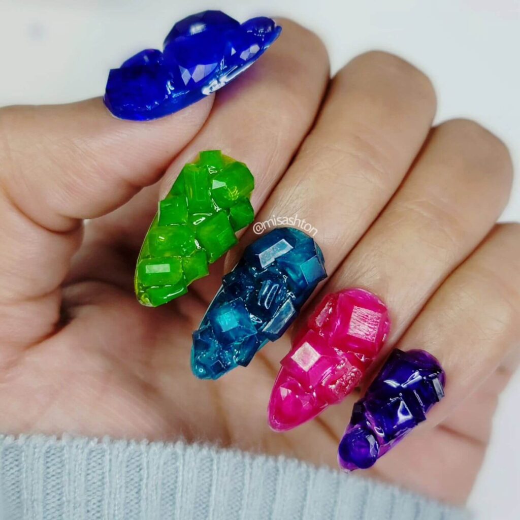 Close-up of candy nails featuring candy cane designs, lollipop nails, and candy corn nails with vibrant colors and intricate patterns.