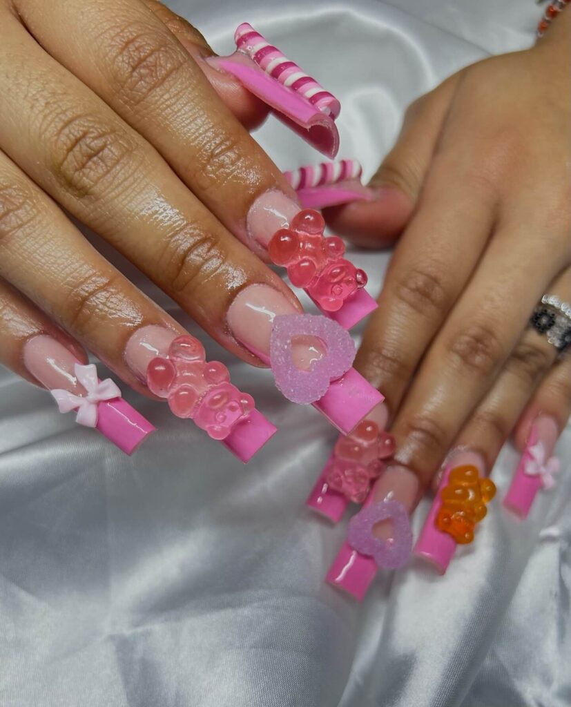 Close-up of candy nails featuring candy cane designs, lollipop nails, and candy corn nails with vibrant colors and intricate patterns.