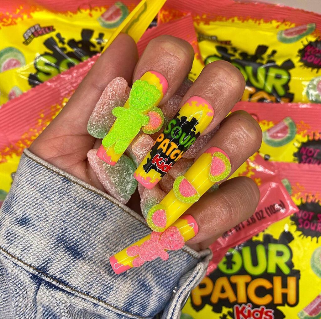 Close-up of candy nails featuring candy cane designs, lollipop nails, and candy corn nails with vibrant colors and intricate patterns.