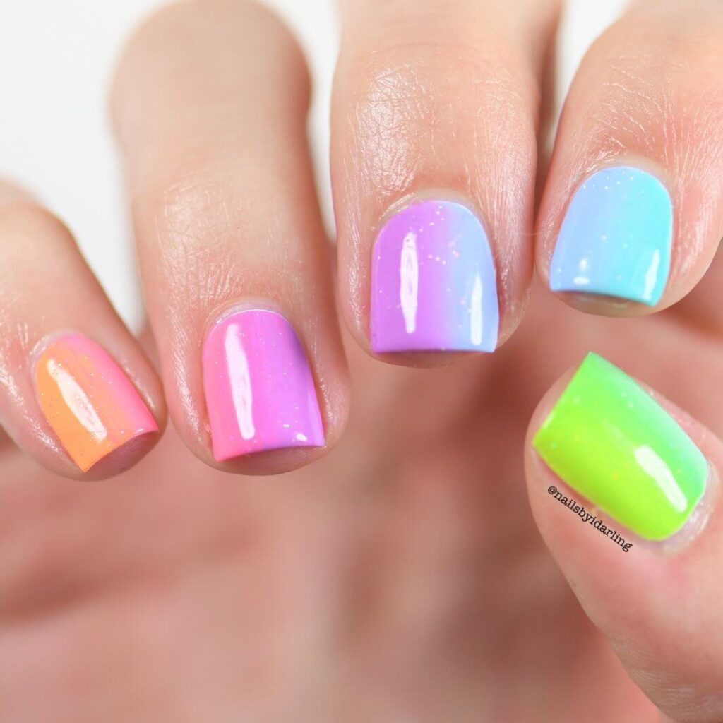 Close-up of candy nails featuring candy cane designs, lollipop nails, and candy corn nails with vibrant colors and intricate patterns.