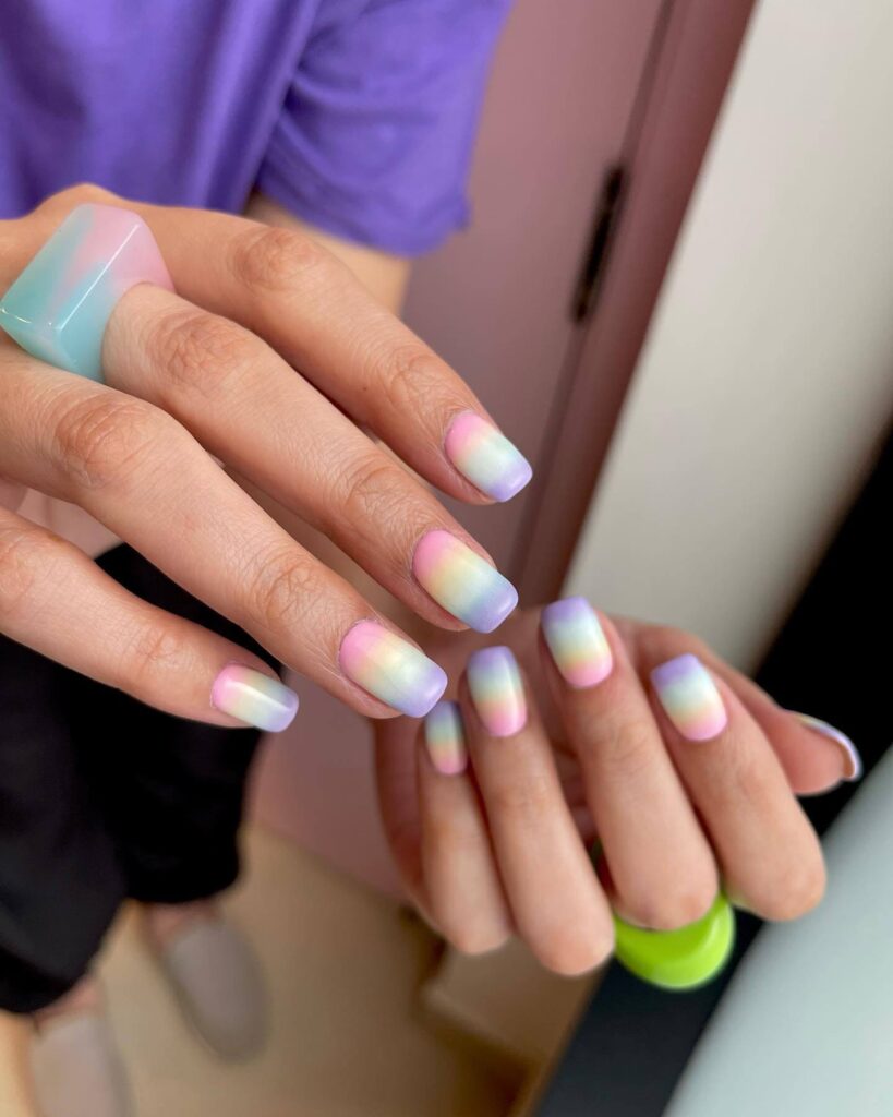 Close-up of candy nails featuring candy cane designs, lollipop nails, and candy corn nails with vibrant colors and intricate patterns.