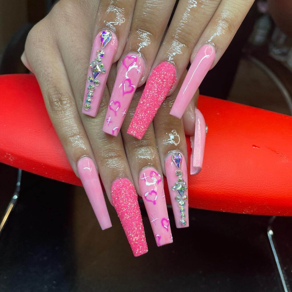 Various pink nail designs including bright pink nail designs, cute pink nail designs, and Christmas nails in pink with intricate patterns and decorations.