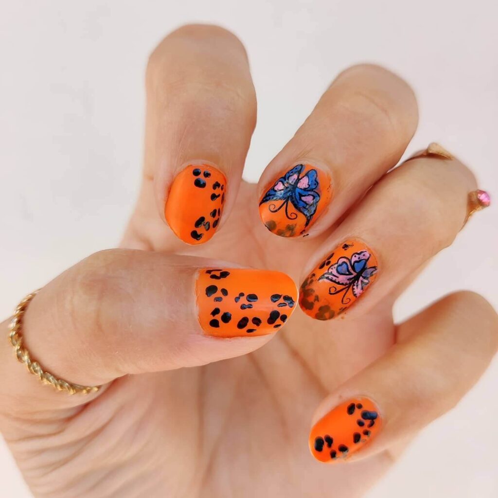 Bright and playful summer nail art with vibrant shades of blue, pink, and yellow, featuring beach-inspired designs and floral patterns.