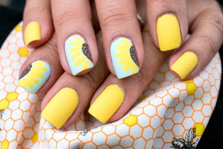 Elegant sunflower nails with intricate designs on both gel and matte finishes, perfect for any season.