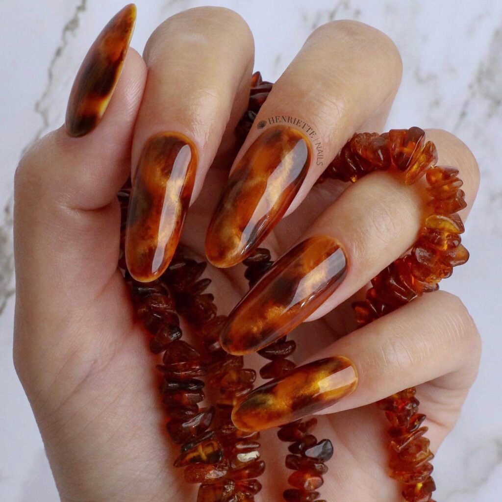 Explore the world of amber nails with creative amber nail art ideas, from amber gel nails to amber acrylic nails and more. Get inspired for your next manicure.