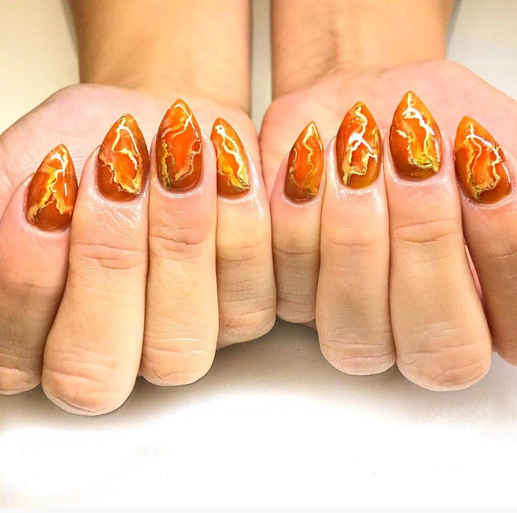 Explore the world of amber nails with creative amber nail art ideas, from amber gel nails to amber acrylic nails and more. Get inspired for your next manicure.