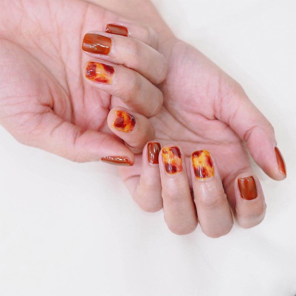 Explore the world of amber nails with creative amber nail art ideas, from amber gel nails to amber acrylic nails and more. Get inspired for your next manicure.