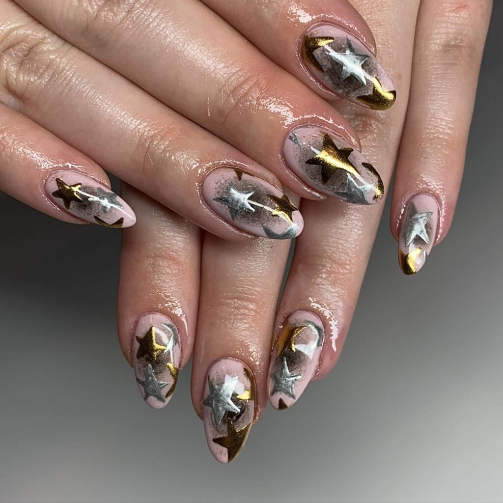 Close-up of hands showcasing various metallic nails designs, including black nails with silver flakes, dark gold nail polish, and metallic red acrylic nails.