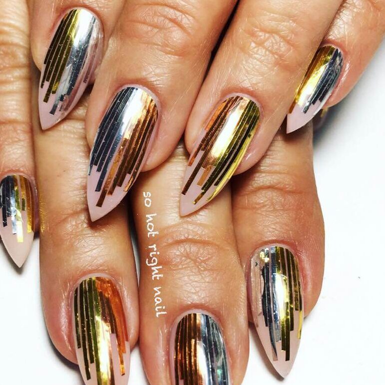 Close-up of hands showcasing various metallic nails designs, including black nails with silver flakes, dark gold nail polish, and metallic red acrylic nails.