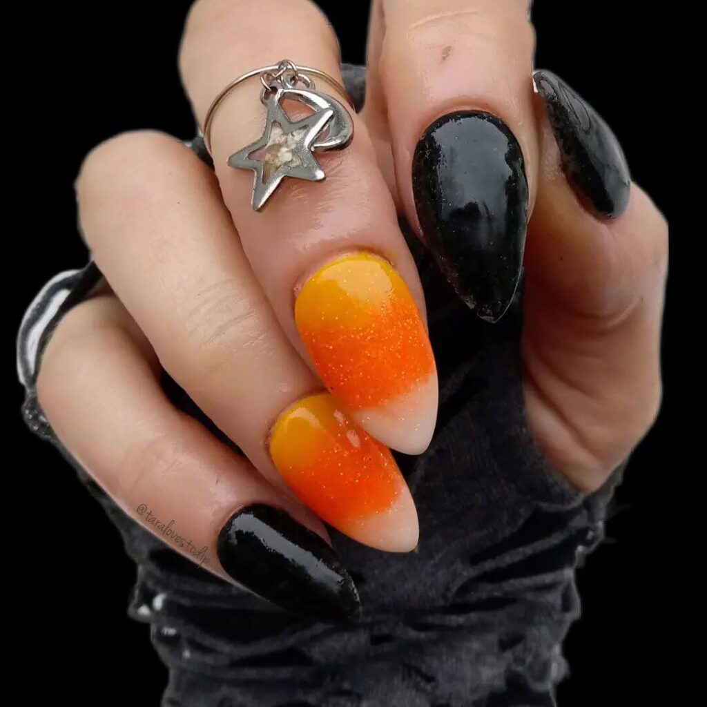 Festive candy corn nails with vibrant Halloween colors and cute designs like pumpkins and scarecrows.