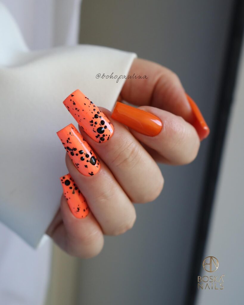 Stylish dark orange nails featuring chic fall designs perfect for autumn vibes.