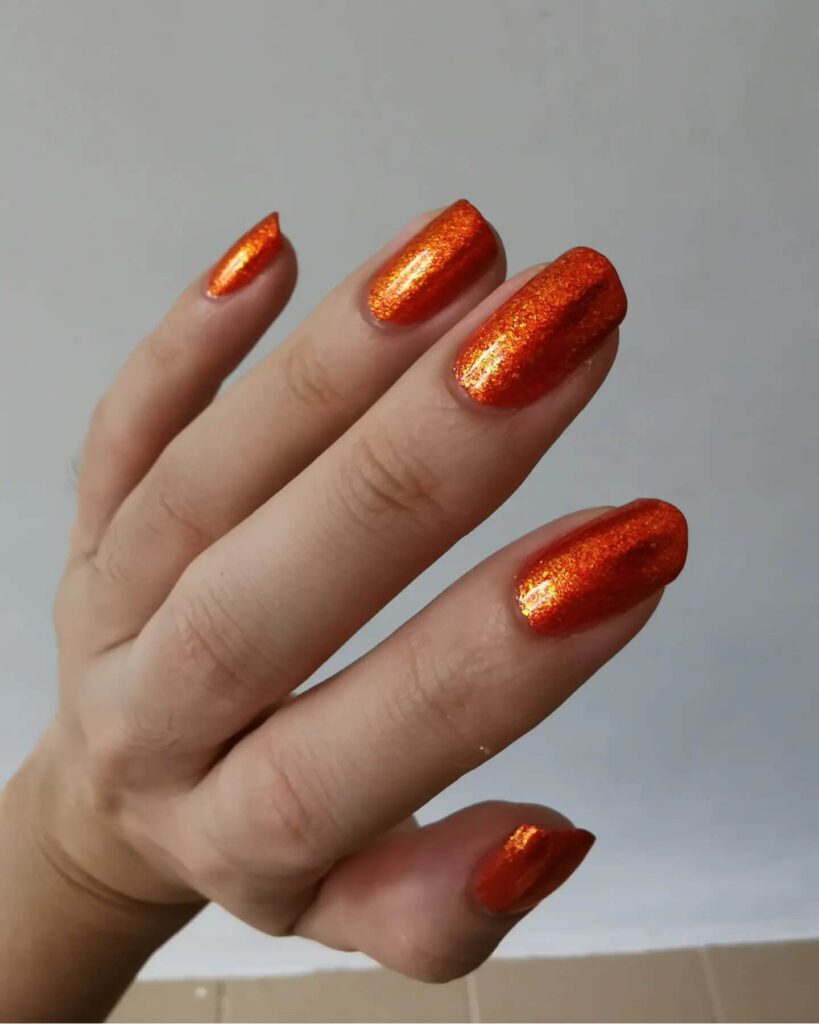 Stylish dark orange nails featuring chic fall designs perfect for autumn vibes.