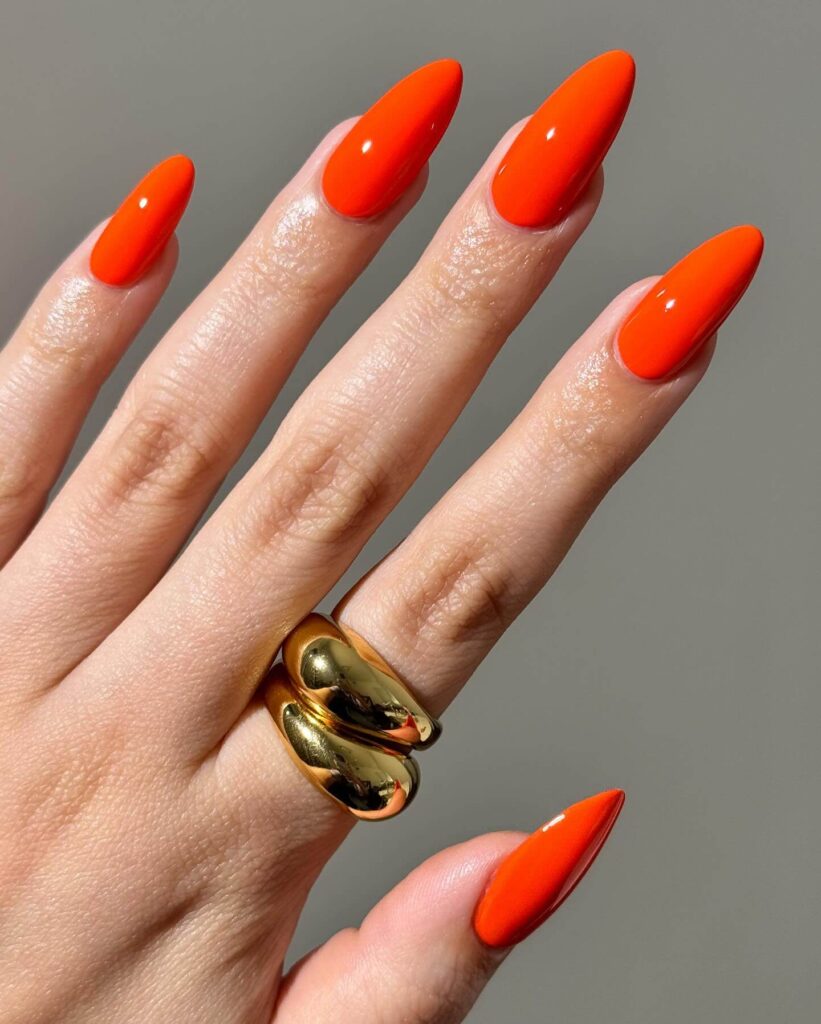 Stylish dark orange nails featuring chic fall designs perfect for autumn vibes.