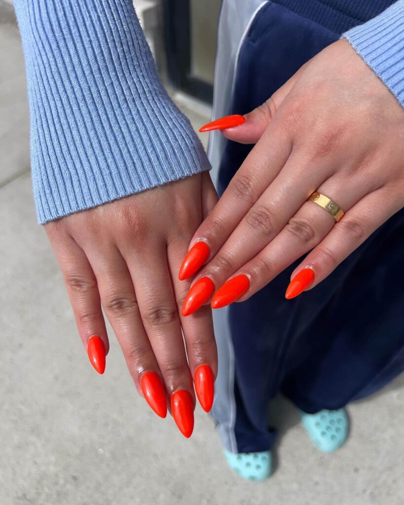 Stylish dark orange nails featuring chic fall designs perfect for autumn vibes.