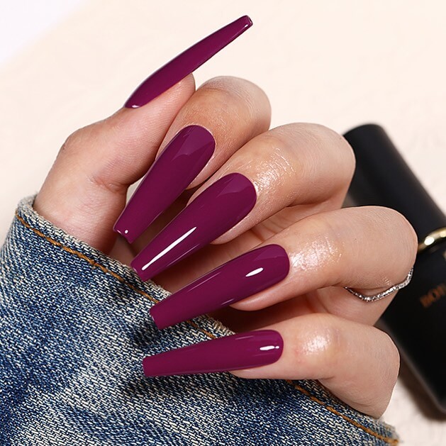 A close-up of elegant dark purple nails with matte purple and ombre nail designs, perfect for both everyday wear and Halloween.