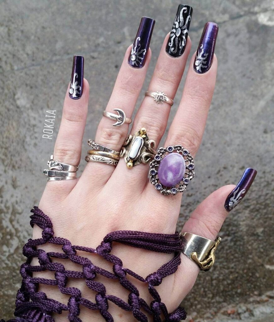 A close-up of elegant dark purple nails with matte purple and ombre nail designs, perfect for both everyday wear and Halloween.