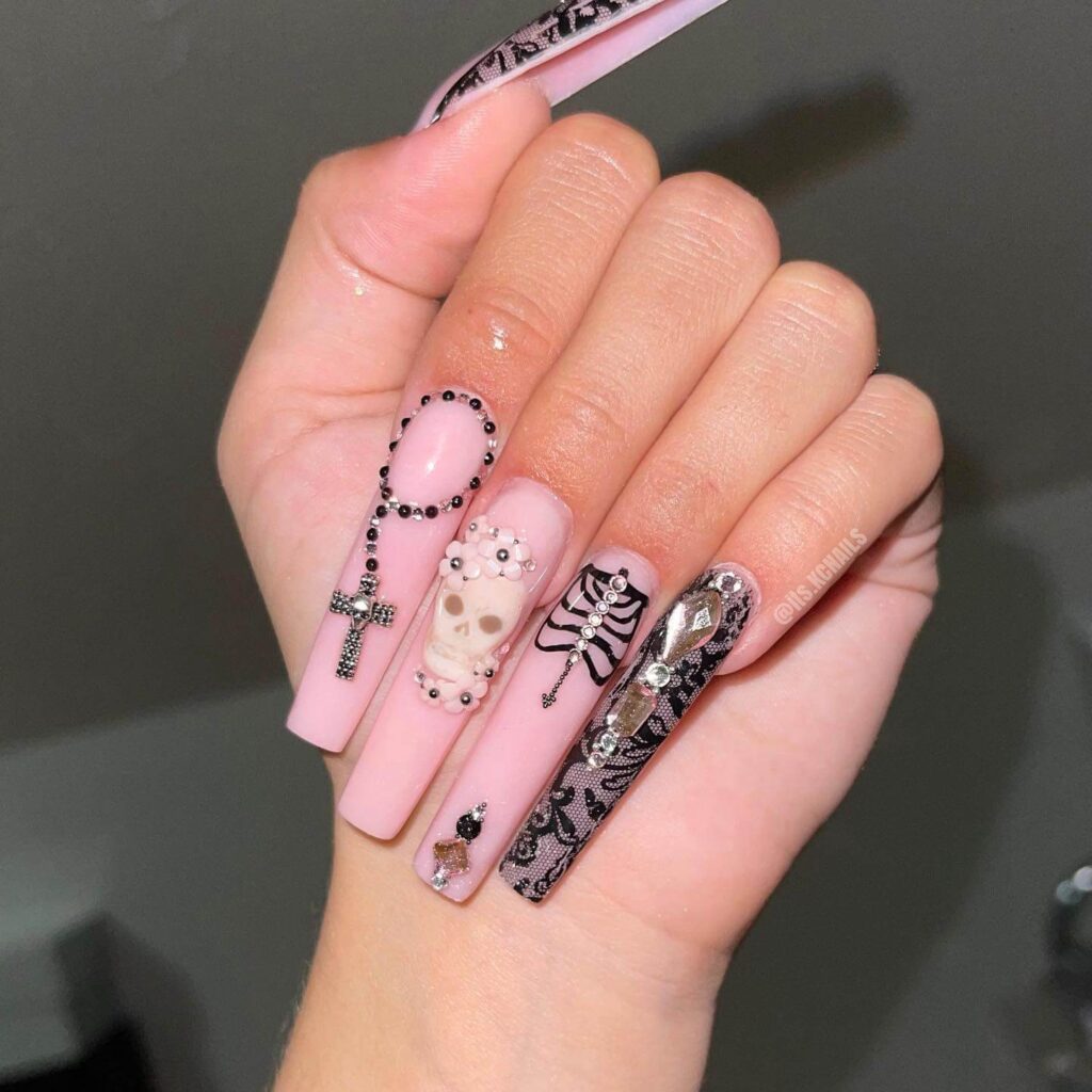 A set of Halloween acrylic nails with spooky nail designs, including black and red accents, ghosts, and candy corn-themed nails.