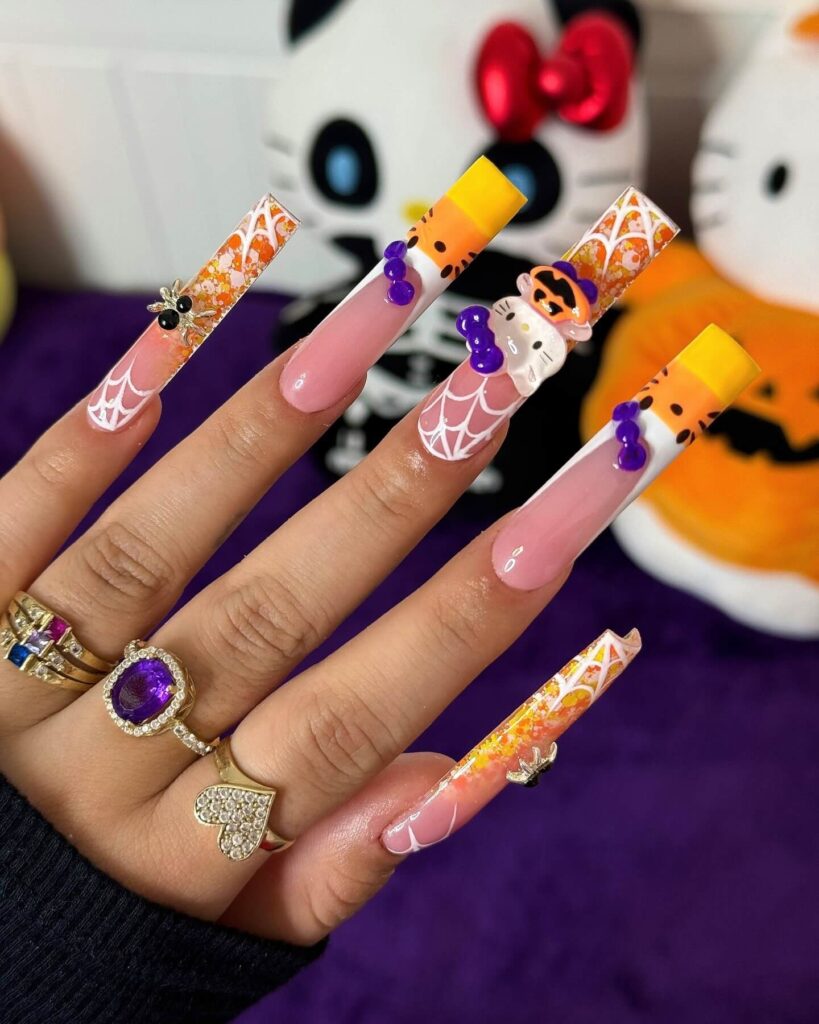 A set of Halloween acrylic nails with spooky nail designs, including black and red accents, ghosts, and candy corn-themed nails.