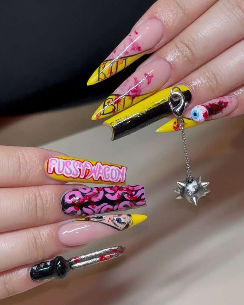 A set of Halloween acrylic nails with spooky nail designs, including black and red accents, ghosts, and candy corn-themed nails.