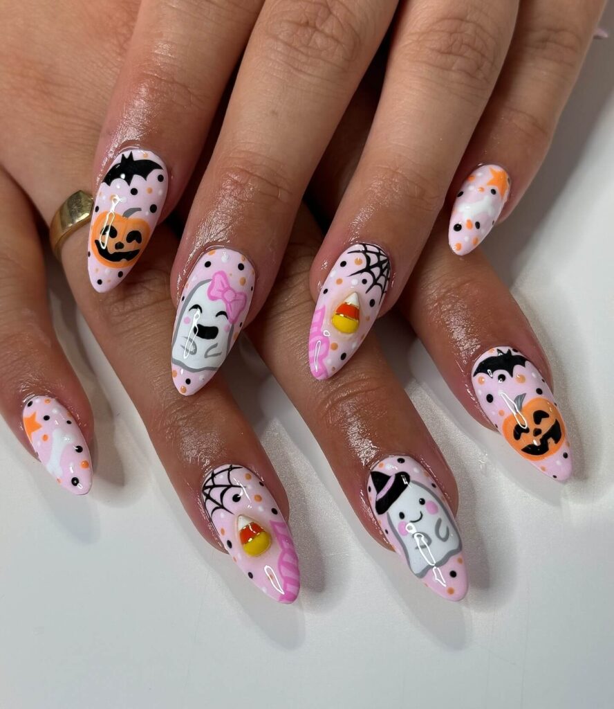 A set of Halloween acrylic nails with spooky nail designs, including black and red accents, ghosts, and candy corn-themed nails.