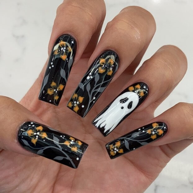 A variety of Halloween nail art designs, featuring ghost nails, pumpkin nails, and spider web nails with a spooky, festive look.