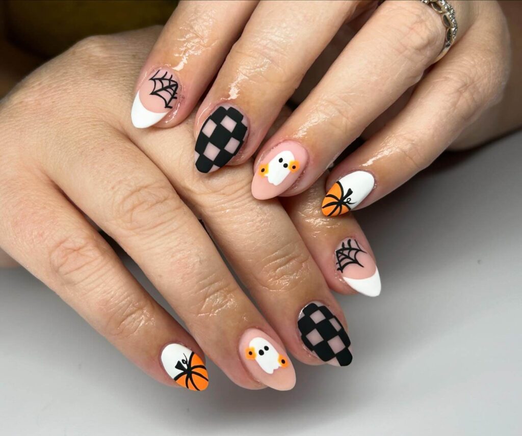 A variety of Halloween nail art designs, featuring ghost nails, pumpkin nails, and spider web nails with a spooky, festive look.