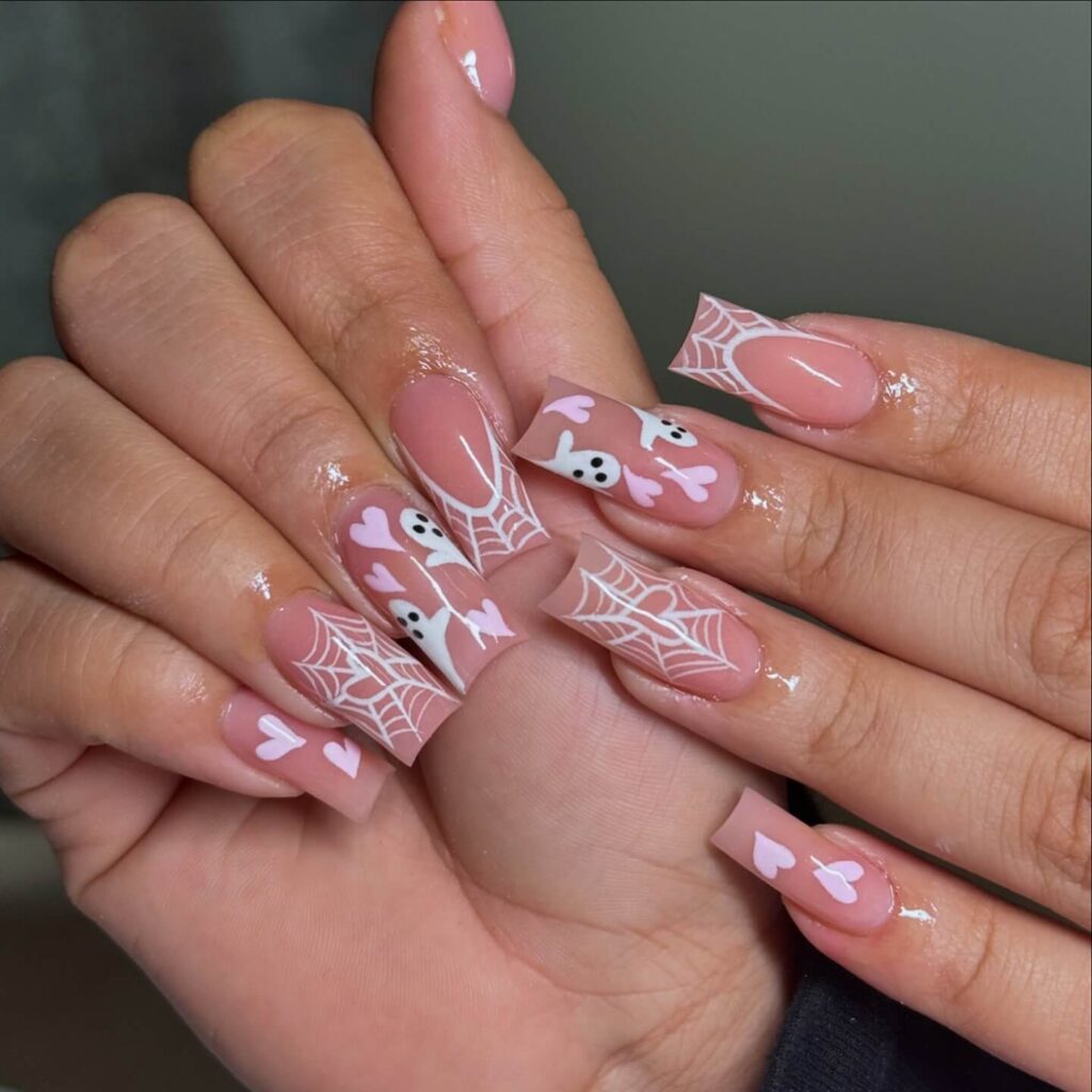 A variety of Halloween nail art designs, featuring ghost nails, pumpkin nails, and spider web nails with a spooky, festive look.