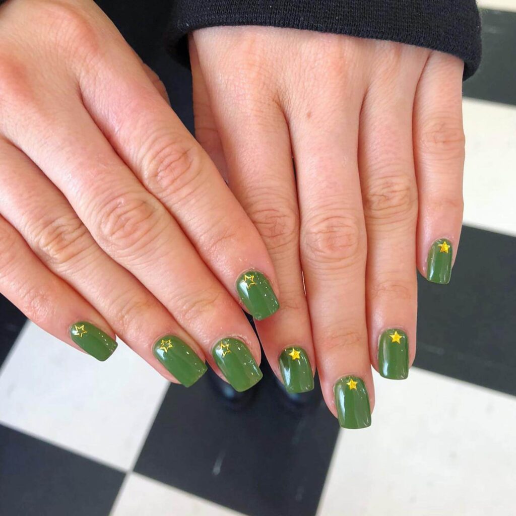 Chic olive green nails featuring gold foil accents and elegant, glossy finishes.