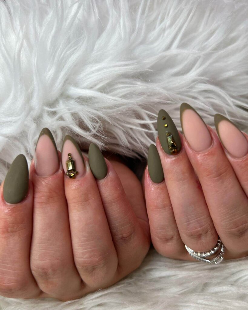 Chic olive green nails featuring gold foil accents and elegant, glossy finishes.