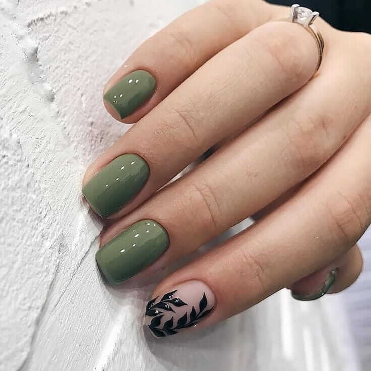 Chic olive green nails featuring gold foil accents and elegant, glossy finishes.