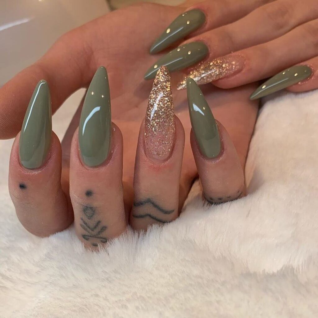 Chic olive green nails featuring gold foil accents and elegant, glossy finishes.