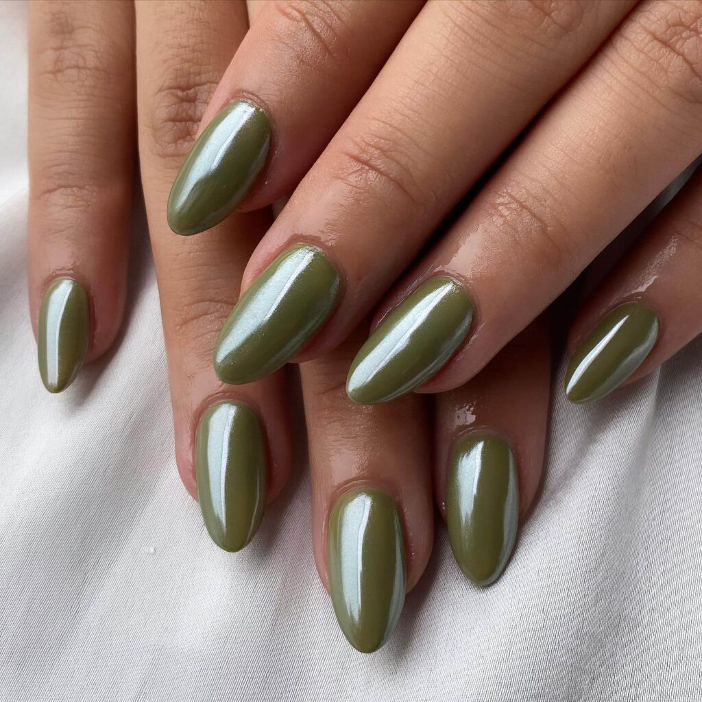 Chic olive green nails featuring gold foil accents and elegant, glossy finishes.