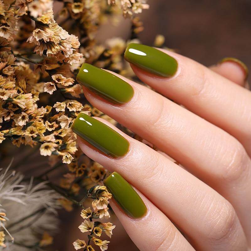 Chic olive green nails featuring gold foil accents and elegant, glossy finishes.