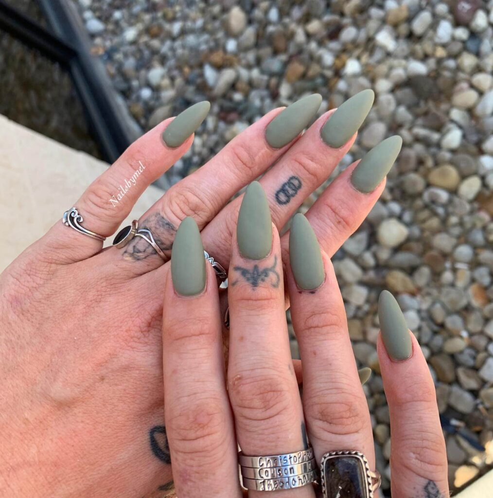 Chic olive green nails featuring gold foil accents and elegant, glossy finishes.