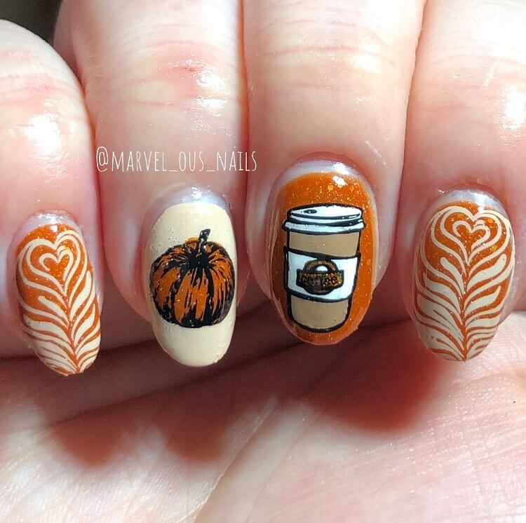 Close-up of warm-toned pumpkin spice nails with a fall-inspired design.